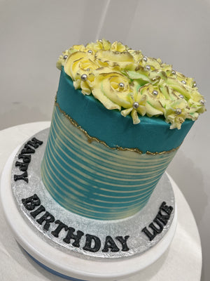 WHITE ROSETTE BLUE OCCASION CAKE