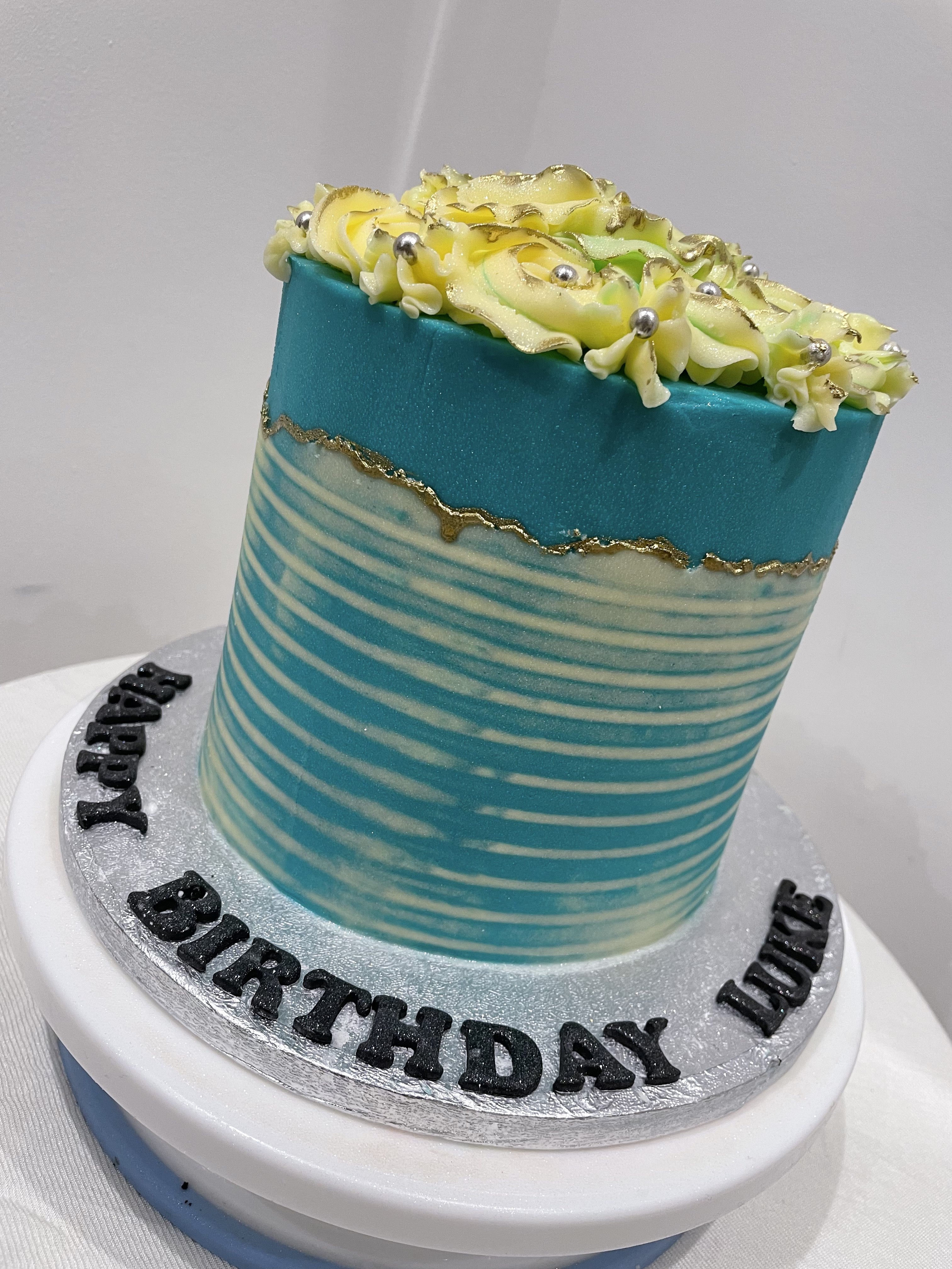 WHITE ROSETTE BLUE OCCASION CAKE