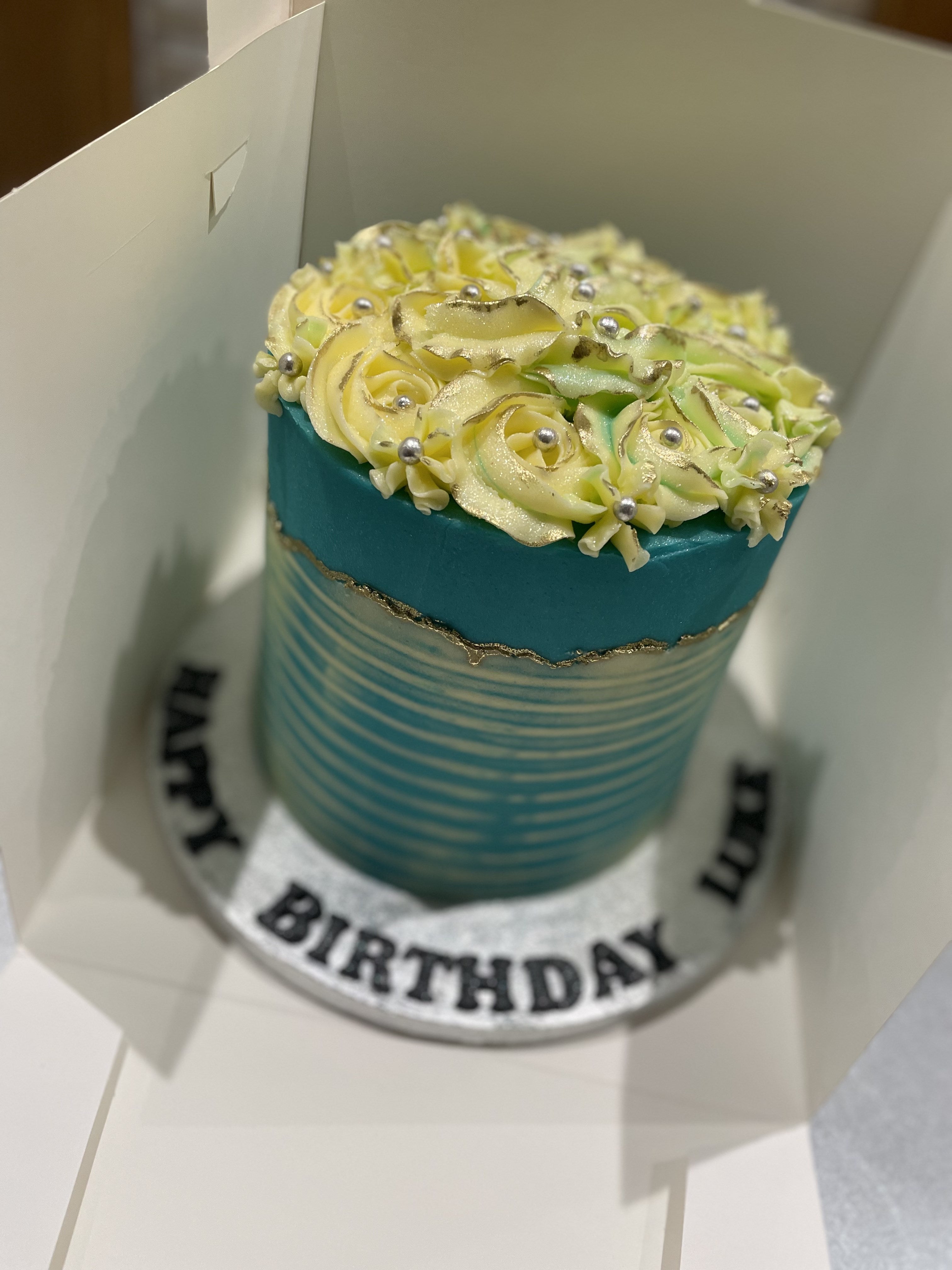 WHITE ROSETTE BLUE OCCASION CAKE