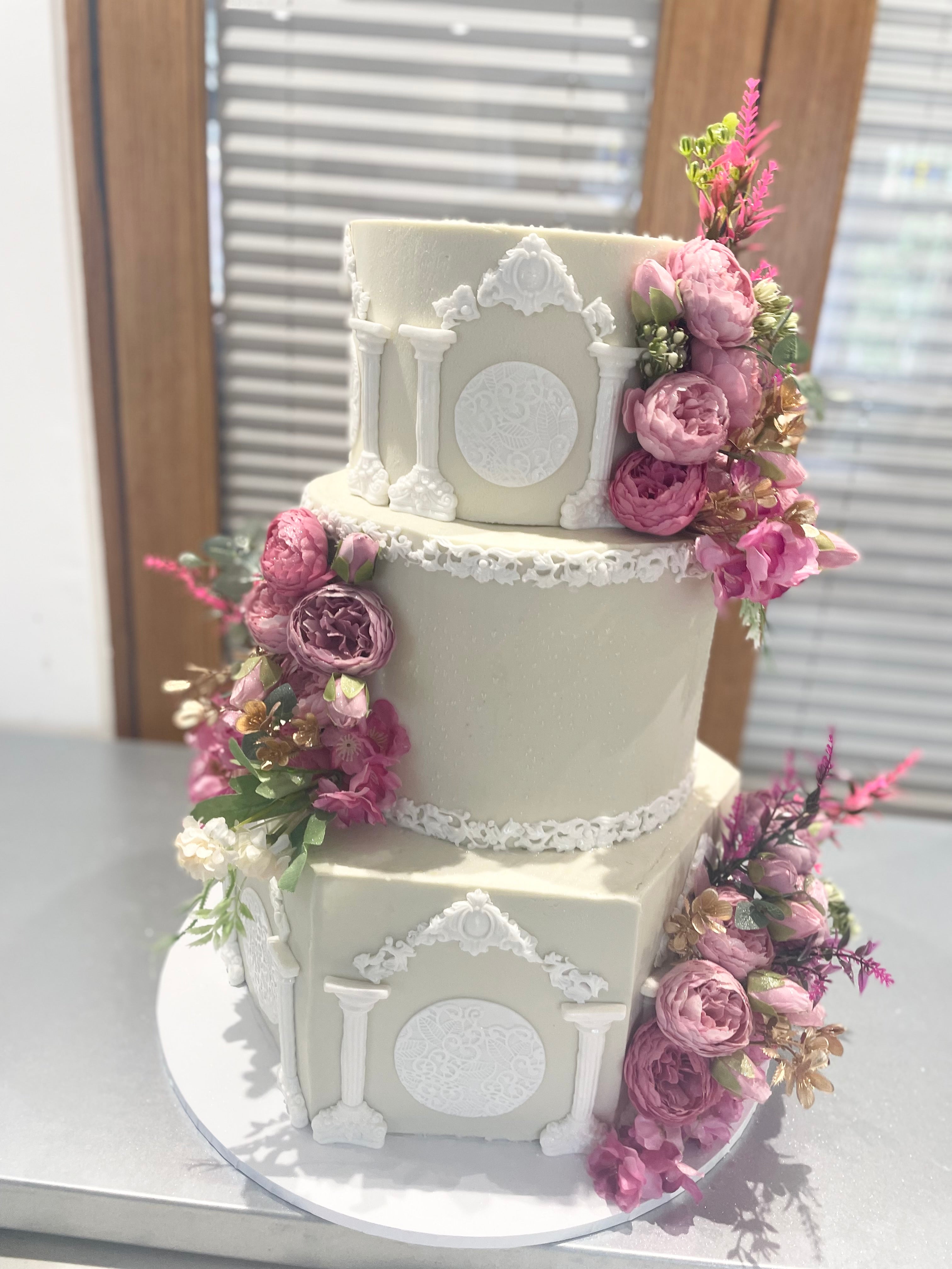 WHITE PILLAR FLORAL WEDDING CAKE