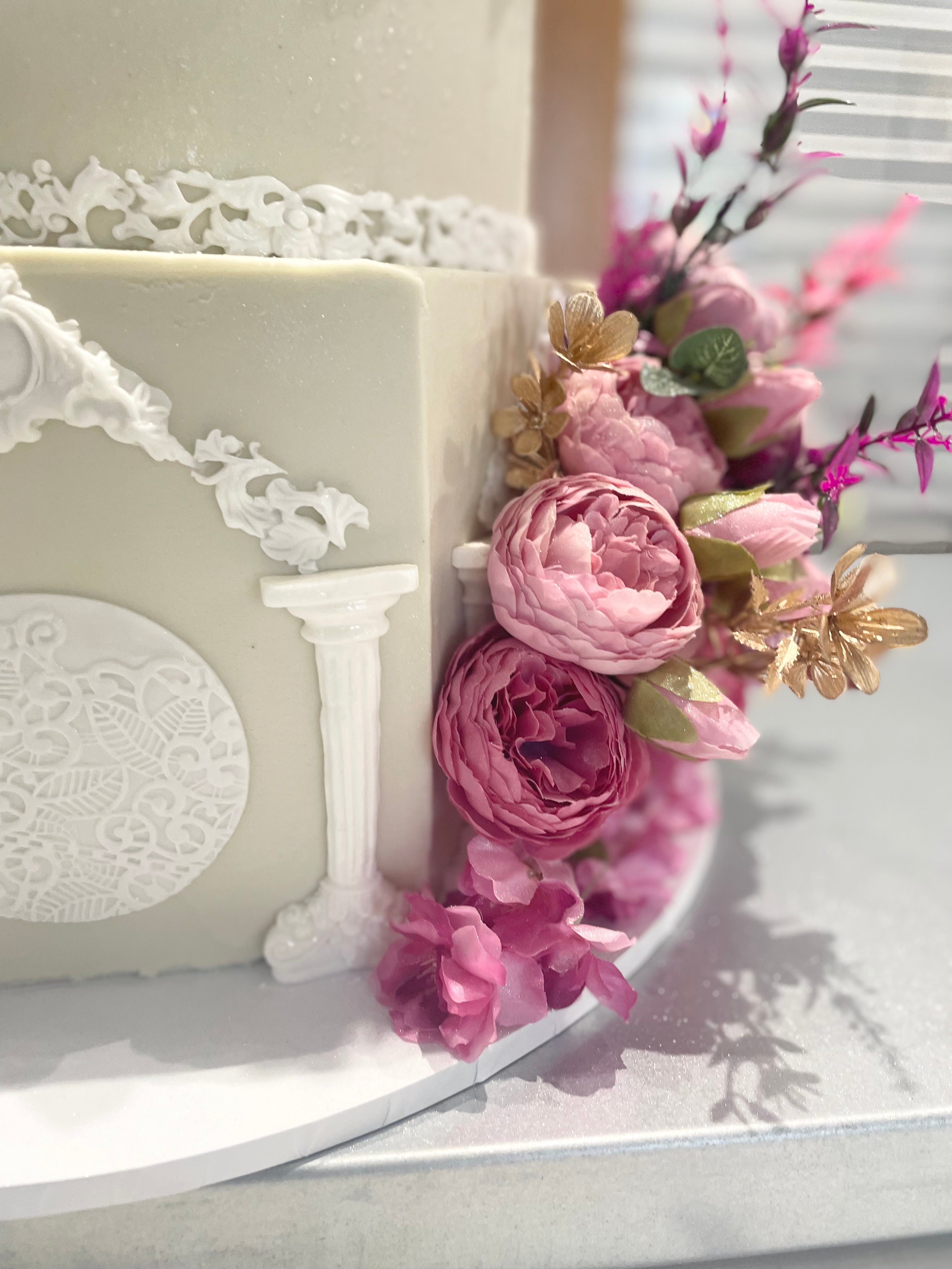 WHITE PILLAR FLORAL WEDDING CAKE