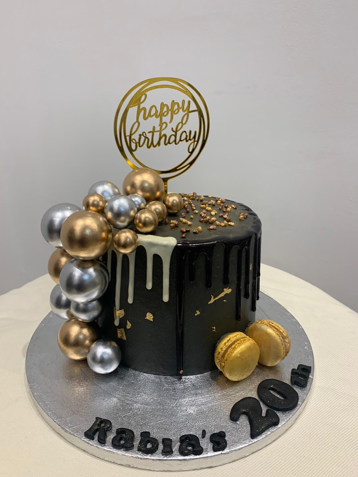 A chocolate cake decorated with silver balls and a candle - Stock Photo -  Dissolve
